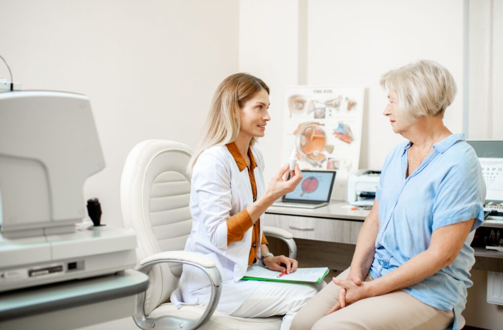 An eye doctor shows their patient how many medicated eye drops to take following their successful laser eye surgery.