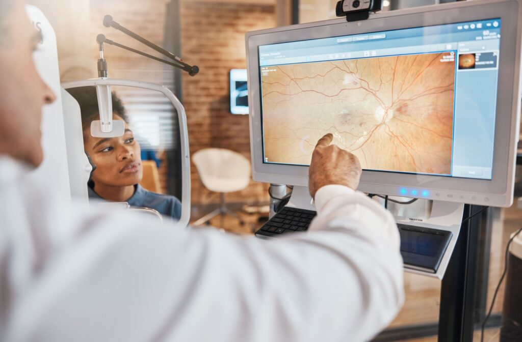 An eye doctor assesses their patient's optic nerve with retinal images.