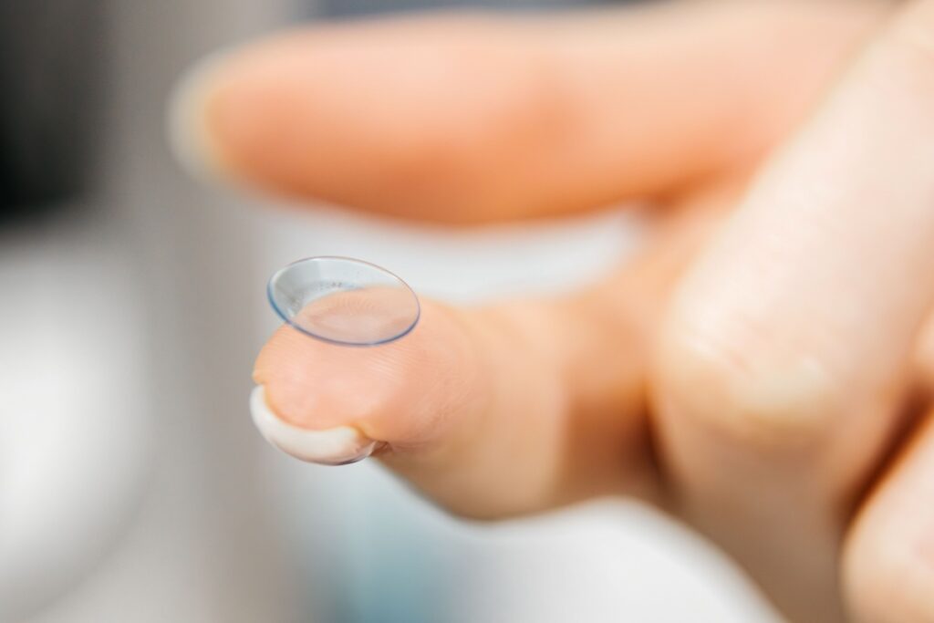 Up close image of contact lens on finger
